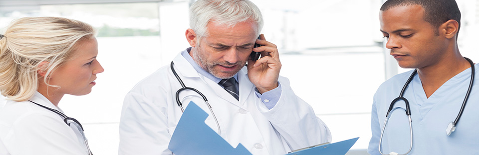 Three healthcare professionals working together