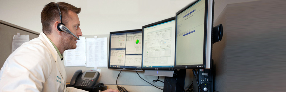 Poison specialist working at a desk with computers