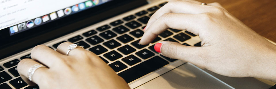 Hands Typing on Laptop Keyboard